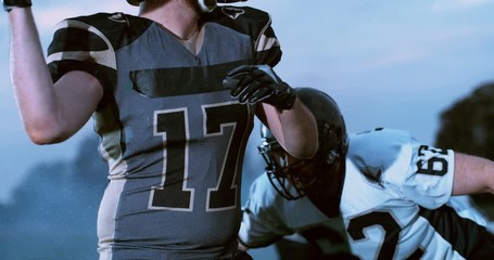 American football players in stadium during game - Powered by Adobe