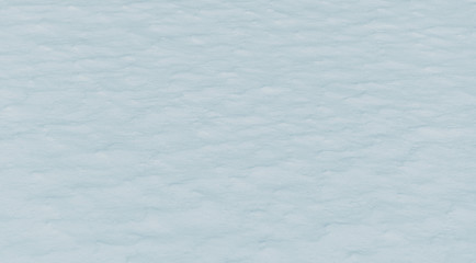 Field covered with snow. Winter background or snow texture.