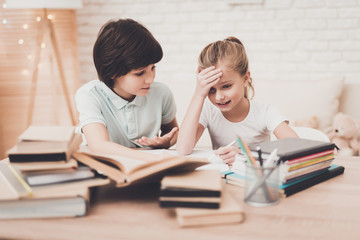 Children at home. Brother and sister are doing homework.