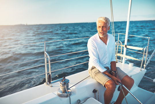 Mature man sailing his boat on the open ocean