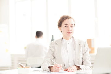 Portrait of young businesswoman working at her workplace at office