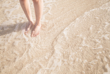 Young woman standing on the beach.
