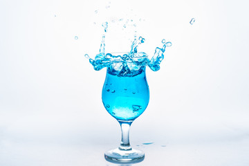 Glass and water splash in white background