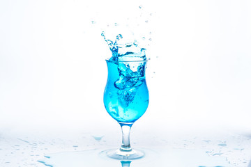 Glass and water splash in white background