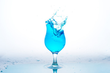 Glass and water splash in white background