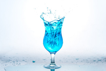Glass and water splash in white background