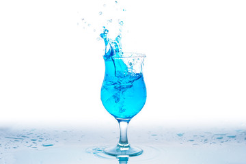 Glass and water splash in white background