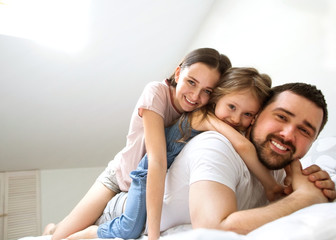 Fototapeta premium family with daughter having fun at home, the concept of a happy family.