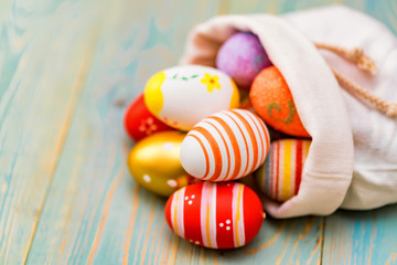 Several colorful Easter eggs in sack close