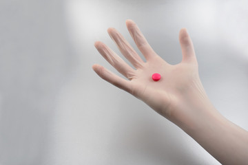 Hand in a latex glove stock images. Hand with a pill. Hand in a rubber glove. Doctor's hand in a white glove