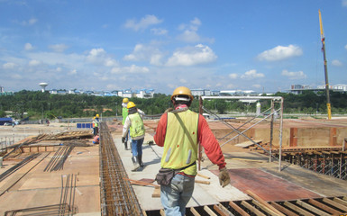 Construction workers fabricating floor slab reinforcement bar at the construction site in Malacca,...