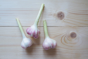 Young garlic on wooden background.
