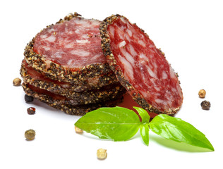 Dried sliced organic salami sausage on white background