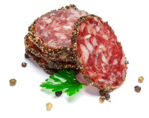 Dried sliced organic salami sausage on white background