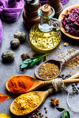 Spices for cooking with kitchen accessories on an old background