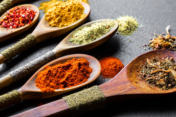 Spices for cooking with kitchen accessories on an old background