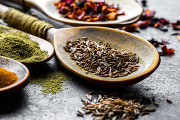 Spices for cooking with kitchen accessories on an old background