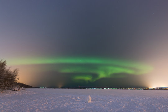 Northern lights on the horizon  in Rovaniemi (Lapland, Finland)