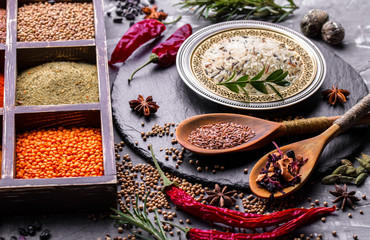 Spices for cooking with kitchen accessories on an old background