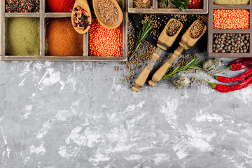 Spices for cooking with kitchen accessories on an old background