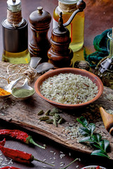 Spices for cooking with kitchen accessories on an old background