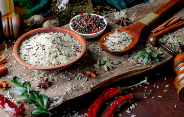 Spices for cooking with kitchen accessories on an old background