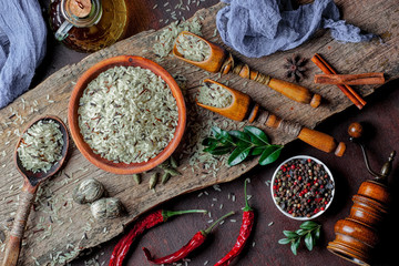 Spices for cooking with kitchen accessories on an old background