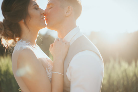Fine art photo of an attractive wedding couple. posing at sunset