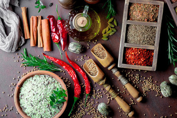 Spices for cooking with kitchen accessories on an old background