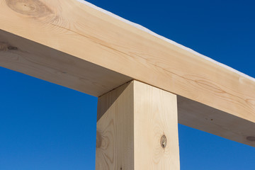 Fototapeta premium New home construction framing against a blue sky, close-up of a ceiling frame.Construction.