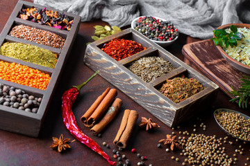 Spices for cooking with kitchen accessories on an old background