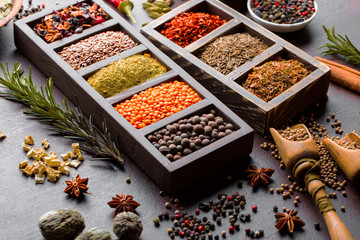 Spices for cooking with kitchen accessories on an old background