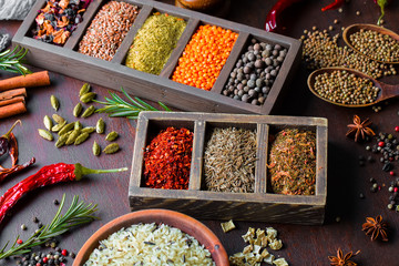 Spices for cooking with kitchen accessories on an old background