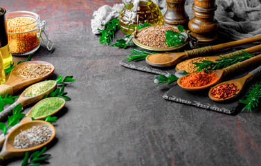 Spices for cooking with kitchen accessories on an old background
