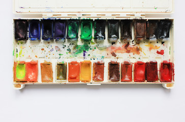 Art Palette with Colorful Paints Close Up Top View. Aquarelle Watercolor Palette at Art Studio with Empty Copy Space. Artist Work Place with Art Supplies, Top View of Art Palette with Various Paints.