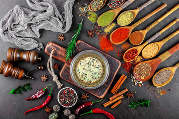 Obraz na płótnie Canvas Spices for cooking with kitchen accessories on an old background