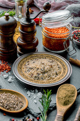 Spices for cooking with kitchen accessories on an old background