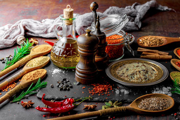 Spices for cooking with kitchen accessories on an old background