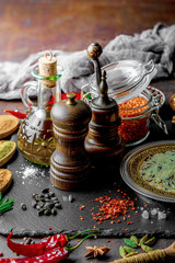 Spices for cooking with kitchen accessories on an old background