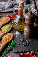 Spices for cooking with kitchen accessories on an old background