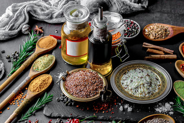 Spices for cooking with kitchen accessories on an old background