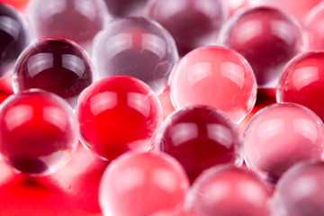 Red shiny water gel balls. Macro photo, can be used both for advertising or cosmetics, jewellery and for medicine. Abstract background.