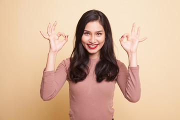 Asian woman show double OK hand sign  and smile.