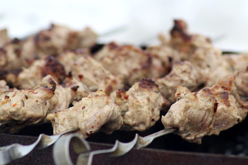 fried meat on charcoal