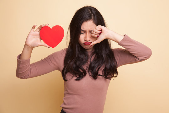 Asian woman sad and cry with red heart.