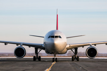 Fototapeta na wymiar Wide-bodied passenger aircraft on the main taxiway