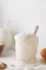 Culinary process of yeast fermentation in the glass in the white kitchen.