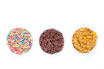 Three bowls of cereals on white background top view.