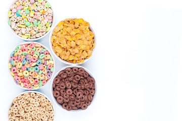 Five bowls of cereals on white background top view