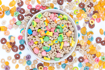 Fototapeta na wymiar Bowl of cereals and marshmallows on white background